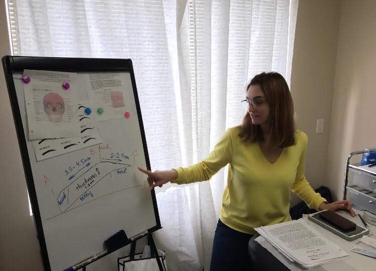 Anna teaching a lesson at a whiteboard in her La Jolla room