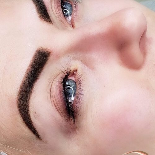 woman after the lash enhancement & eyebrows powder technique done
